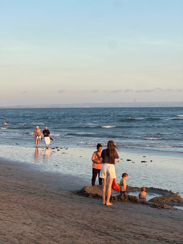 Golden hour crowd scene on a North Kuta beach