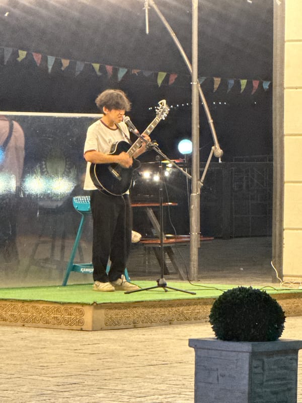 Live street music on a Pavlodar walkway, summer night