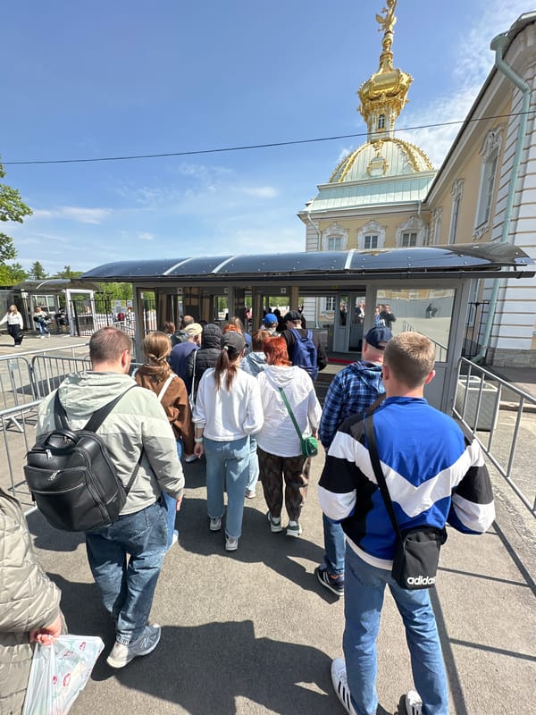 Tourists visit Peterhof Palace grounds during morning hours