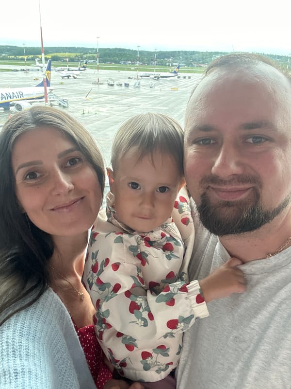 Family with toddler watches planes at Kraków Airport