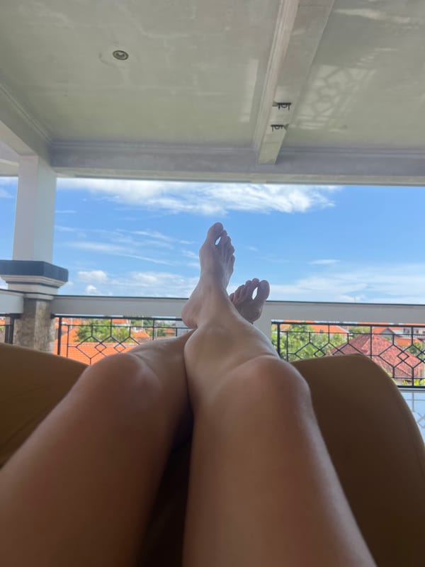 Morning relaxation captured on Canggu balcony with pet