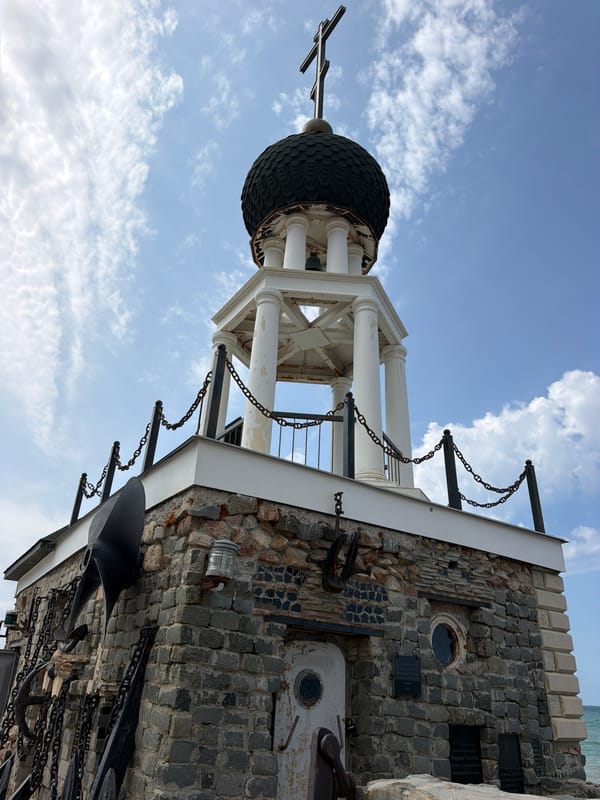 Stone maritime memorial with anchors and ship sculpture, coastal Ukraine