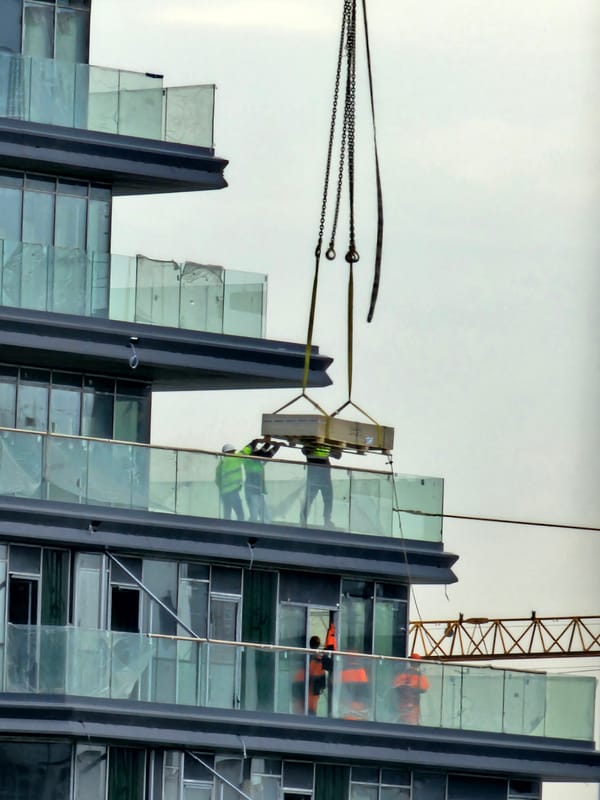 Crane lifts materials to upper floors at Moscow construction site