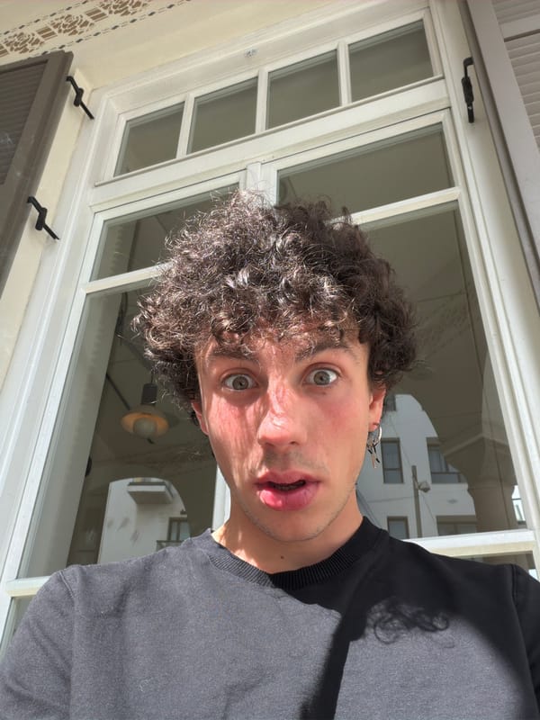 Man with surprised expression photographed through window in Tel Aviv