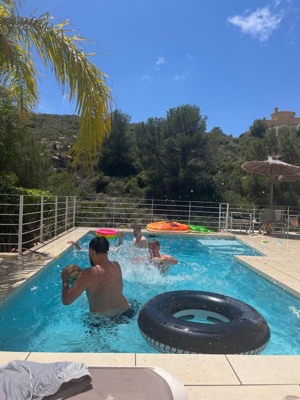 Young men enjoy pool games in Spanish coastal town