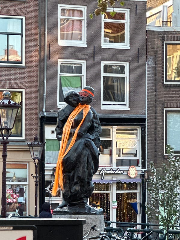 Anne Frank statue with orange ribbons spotted along Amsterdam canal