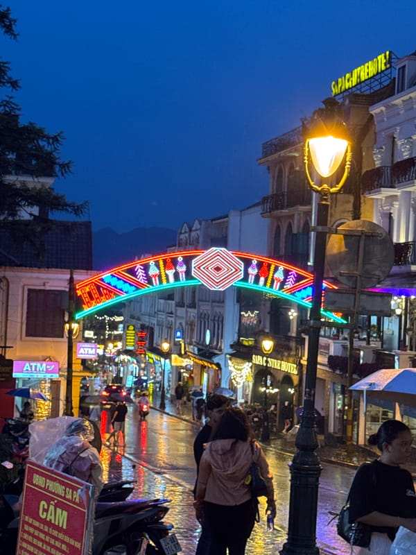 Sa Pa's Sun Plaza glows at dusk beneath neon lights