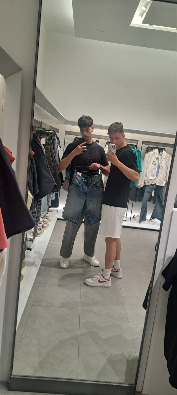 Two men take selfie in Burgas clothing store mirror
