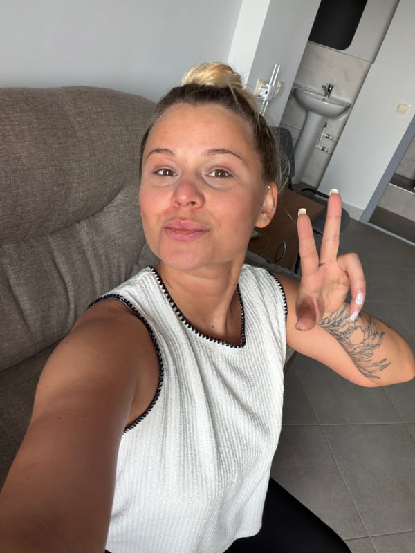 Woman makes peace sign on sofa in Sarapul