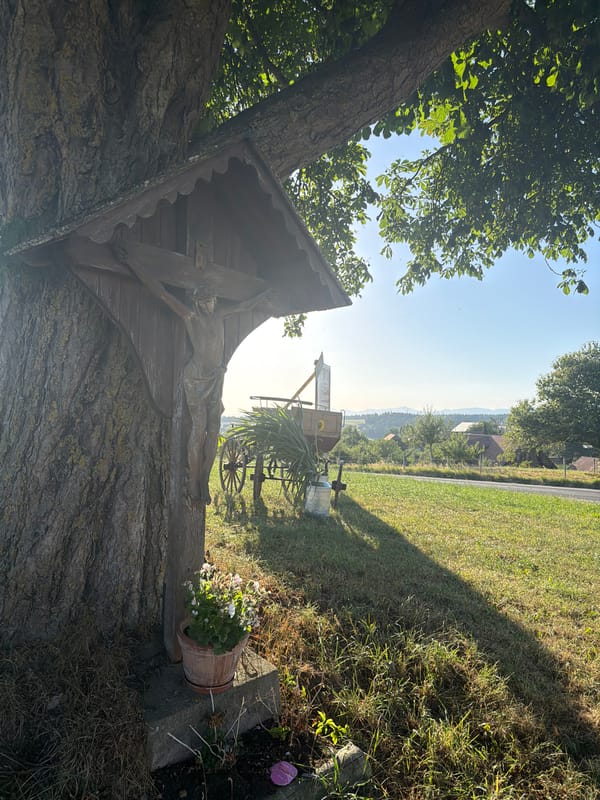 Vintage carriage, wayside shrine, and summer afternoon in Ufhusen