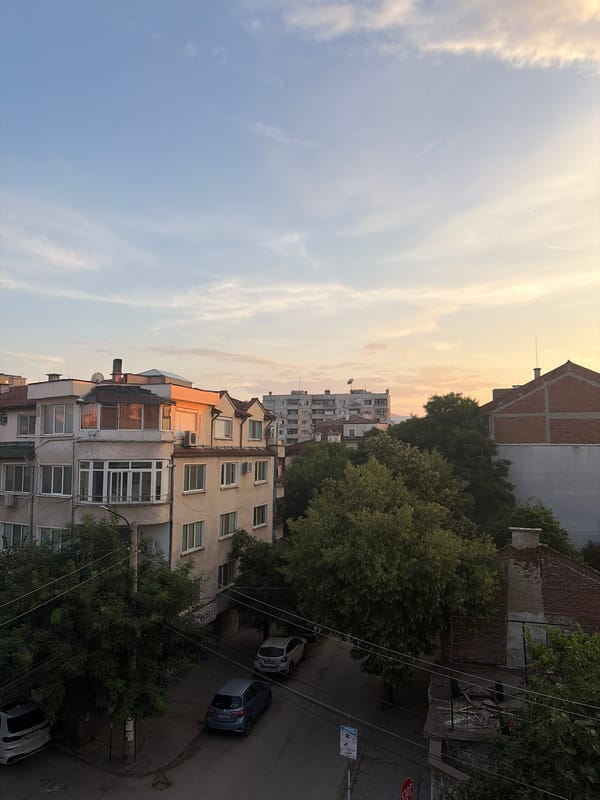 Balcony and street views of a city at sunset