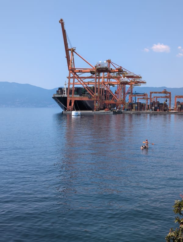 Rijeka's beach and port coexist on a busy summer morning