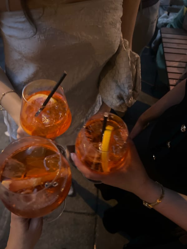 Friends share Aperol Spritz cocktails at London bar gathering
