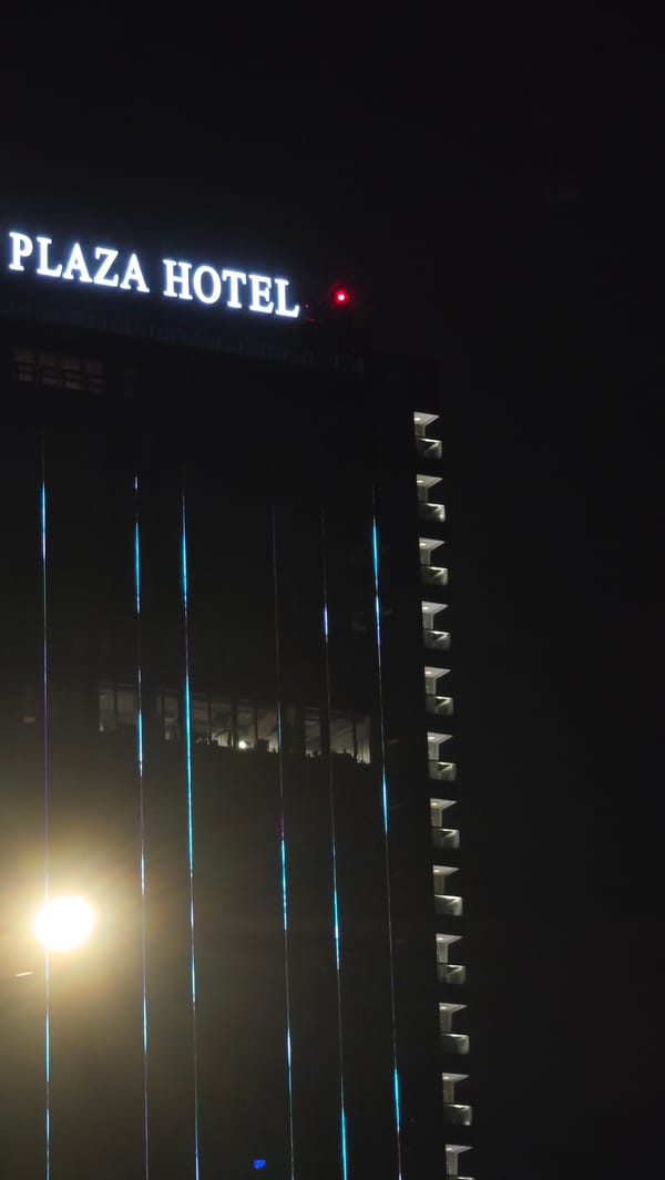East Plaza Hotel illuminated with purple lights in Sofia