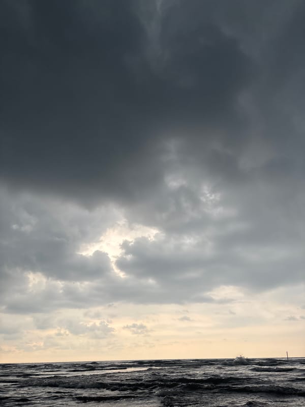 Beachgoers witness dramatic storm clouds in Angkleng Barat, Indonesia