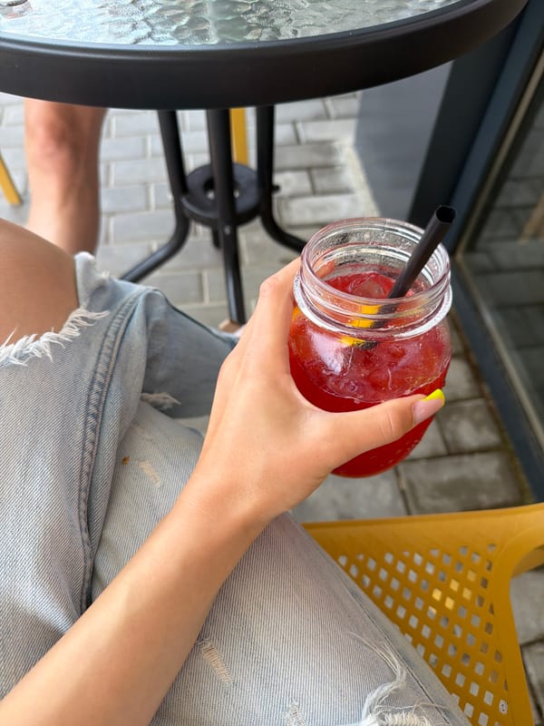 Person enjoys beverage at outdoor cafe in Veliko Tarnovo