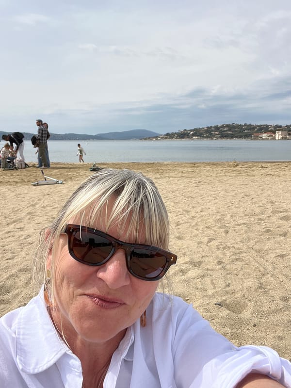 Women relax on Sainte-Maxime beach during overcast morning
