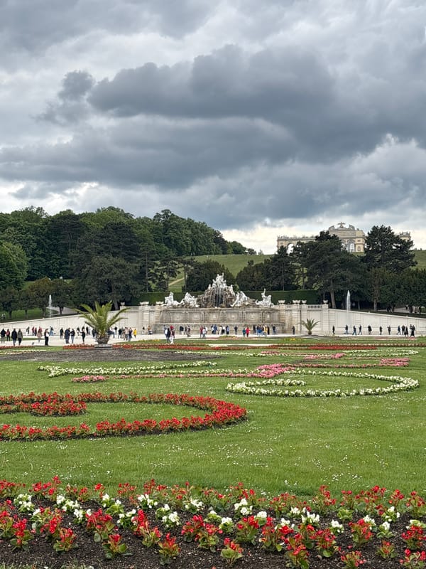 Visitors explore Schönbrunn Palace gardens on cloudy Vienna morning
