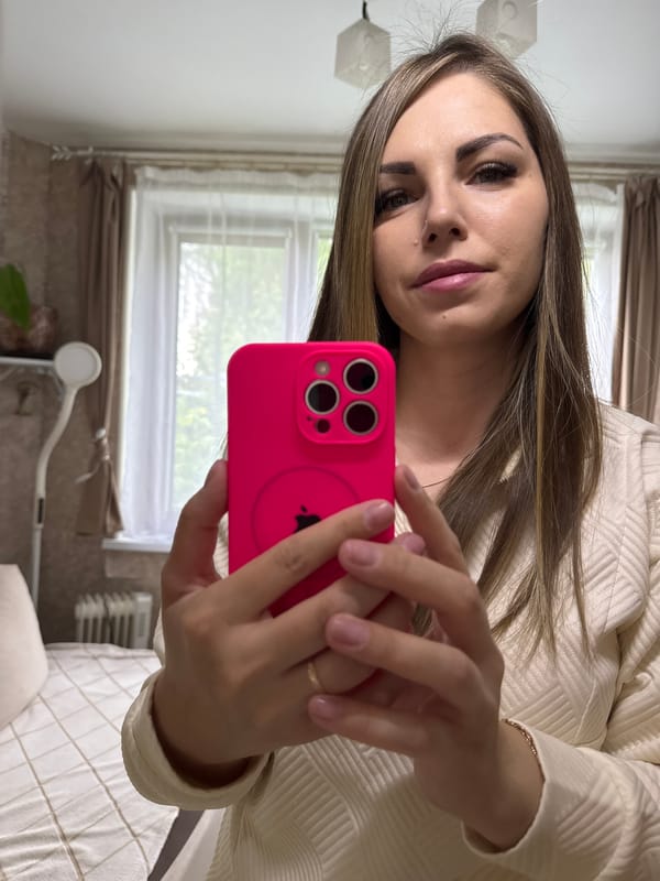 Woman takes selfies with pink iPhone in Russian residence