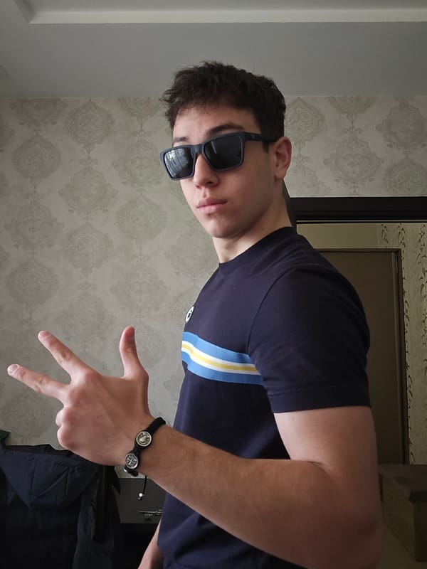 Young man poses indoors in Yerevan wearing striped shirt