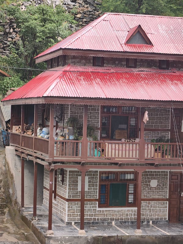 Morning mist and traditional architecture observed in Vashisht