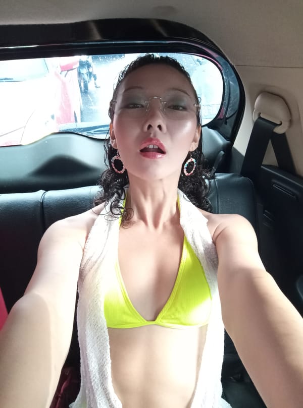 Two women take selfies with energy drinks in North Kuta