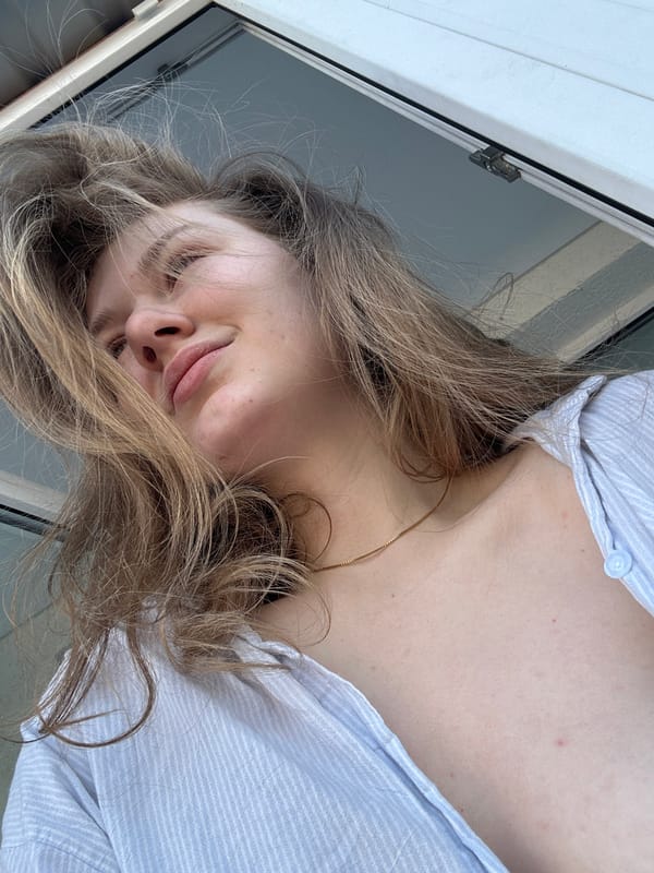 Woman resting in pajamas near window in Kazan
