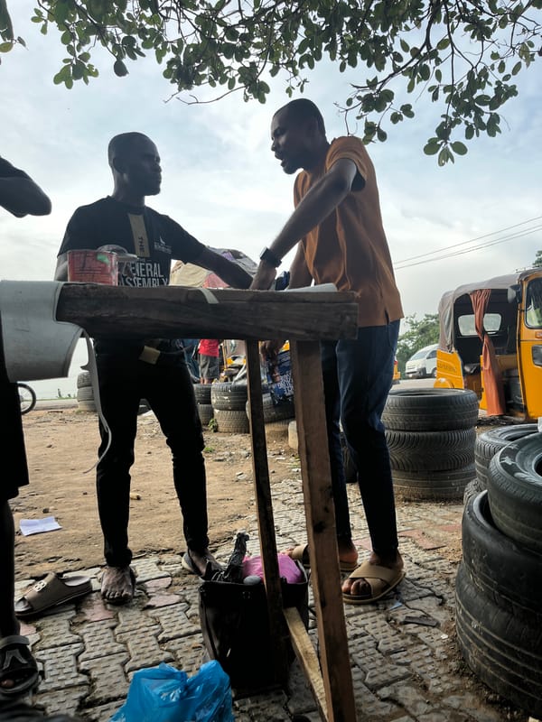 Everyday street life along a busy Abuja roadside