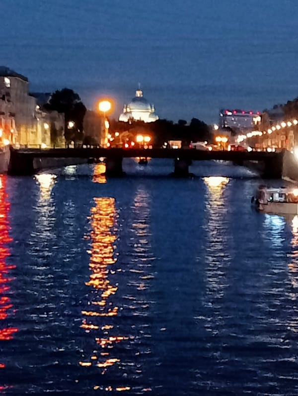 Saint Petersburg landmarks glow along the Neva at dusk