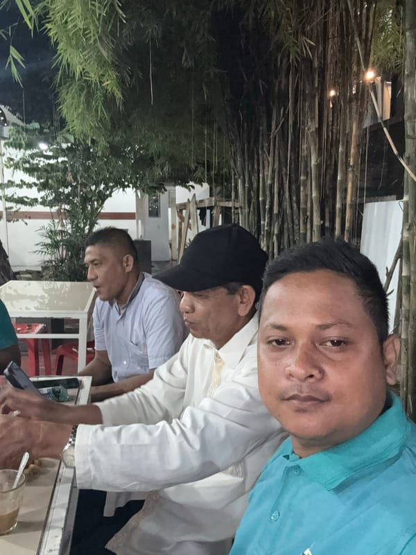 Men gather for casual outdoor meal in Lhokseumawe