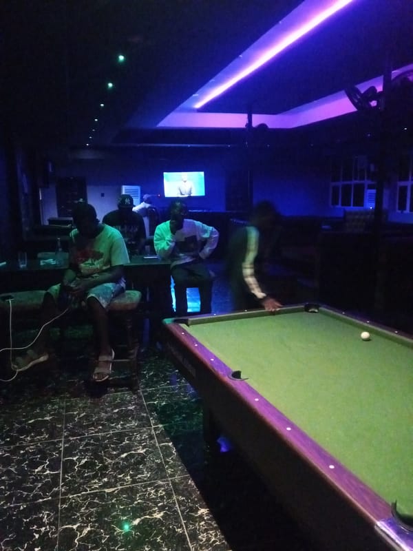 Pool, DJs, and colored lights at a Lokoja night venue.