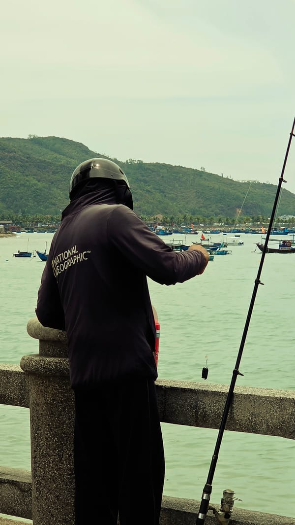 Early morning angler fishes from pier in Nha Trang