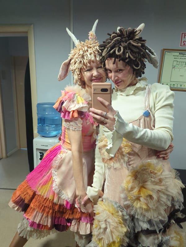 Costumed women take selfies at Moscow venue