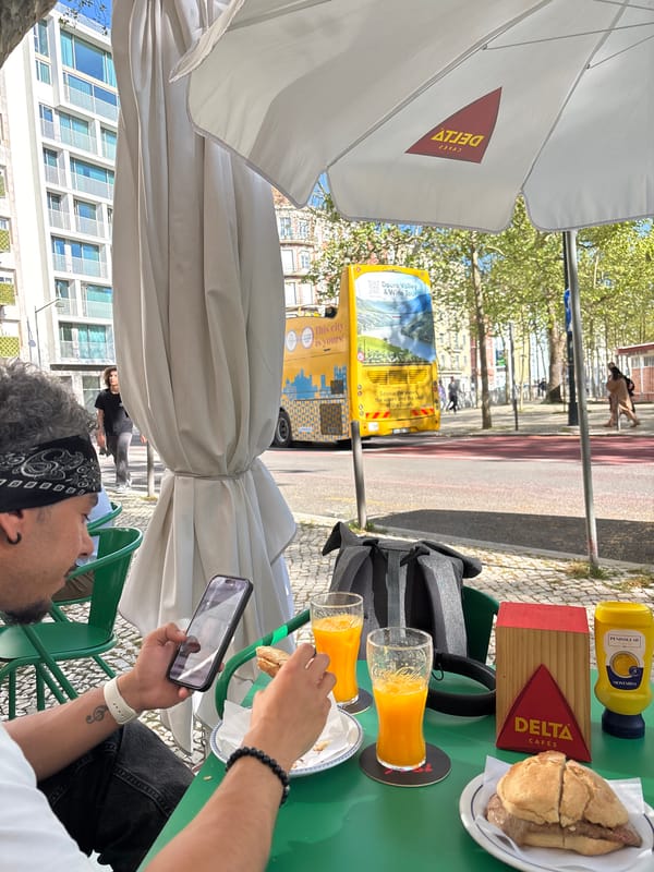 Solo diner enjoys meal while using phone at Lisbon cafe