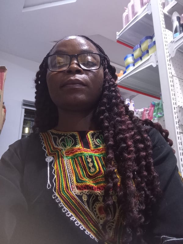Selfie session in a Nigerian retail store, colorful embroidered top