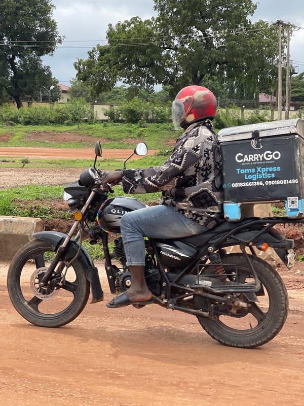 Motorcycle rider in red helmet on Abuja streets