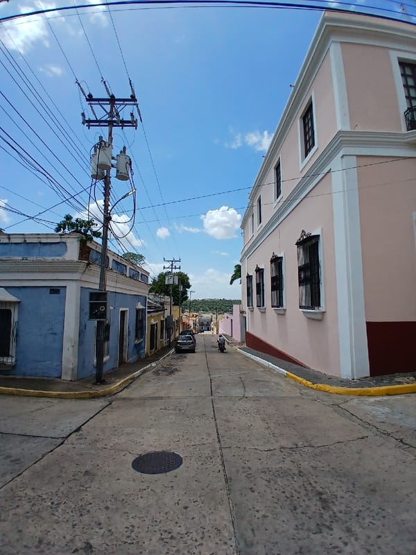 Tourist documents Ciudad Bolivar architecture and South American flag display