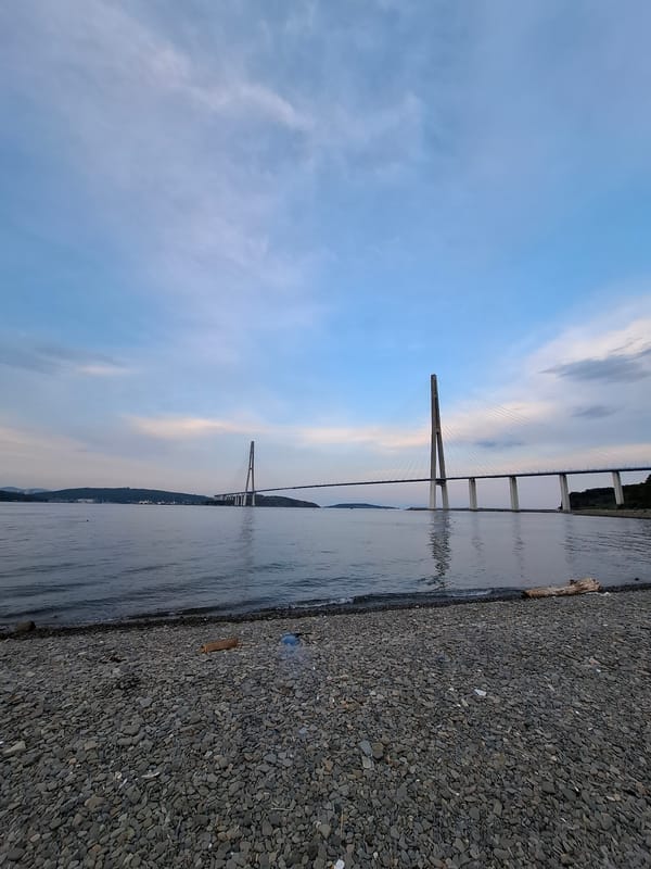 Dusk at Russky Island beach, bridge and shoreline in focus