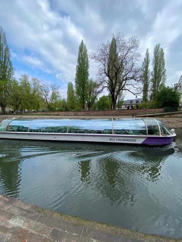 Tourist boats navigate Strasbourg canals during afternoon sightseeing tours