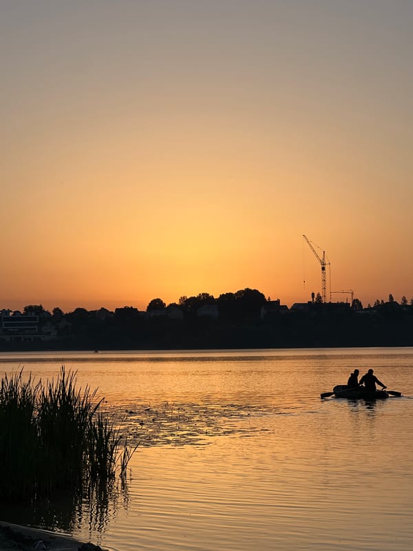 Golden sunset at Ternopil Pond, figure wading in the shallows