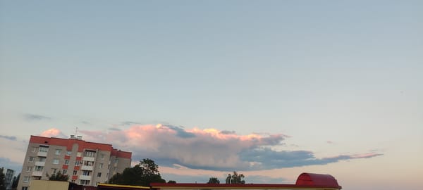 Zelva at dusk: apartment blocks and open meadows on the edge of town