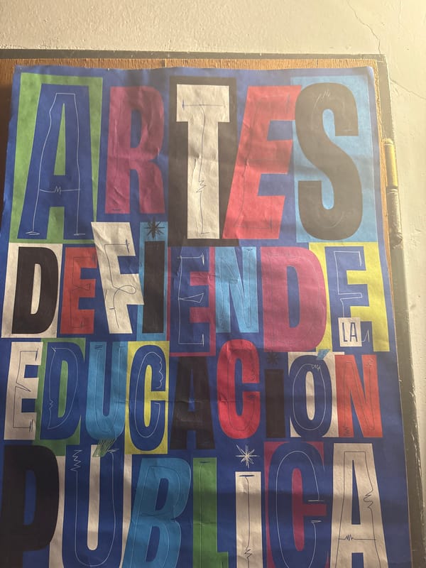 Indoor workspace and educational poster documented in La Plata