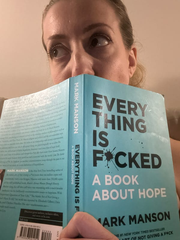 Woman reads Mark Manson book in Amsterdam evening session