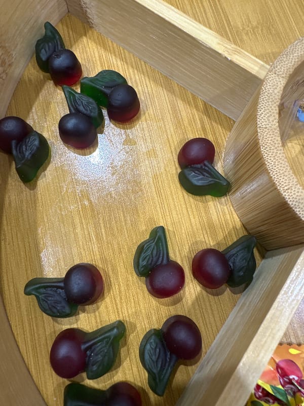 Cherry gummy candies scattered on wooden surface in Yerevan