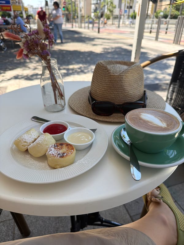 Coffee, a straw hat, and sunglasses at a Bat Yam café