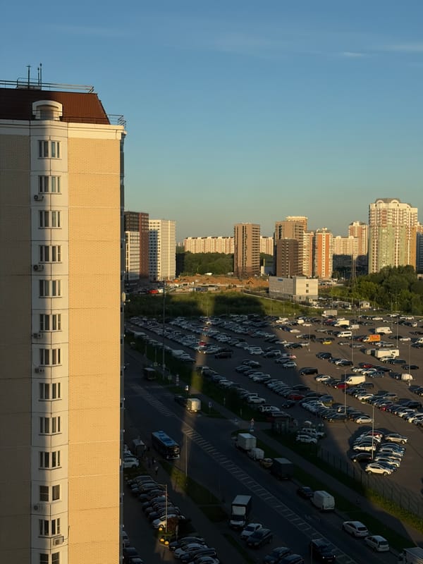Toddler plays on a bed in a Moskovskiy apartment, summer evening.