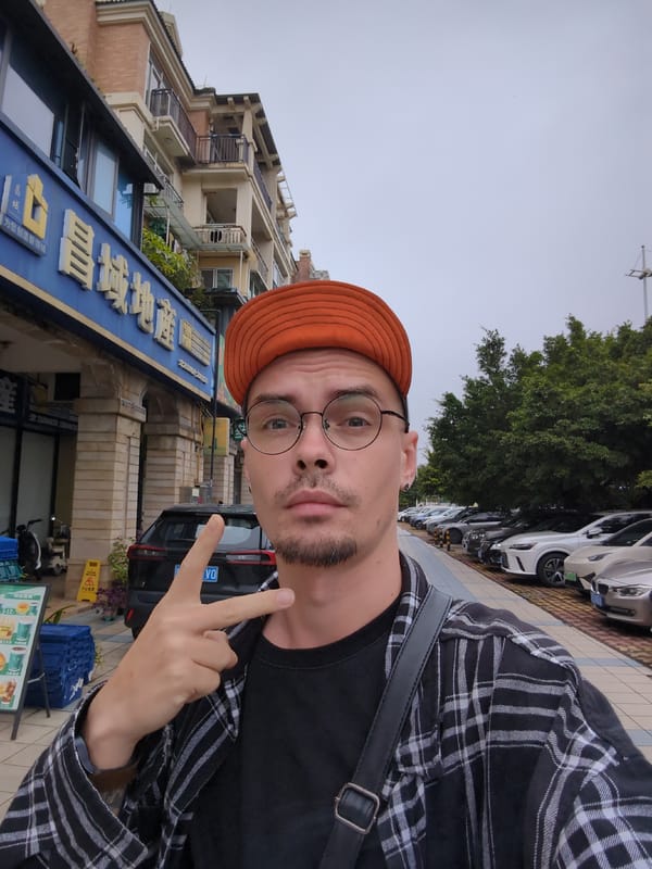 Man in orange hat takes peace sign selfie in Shunde