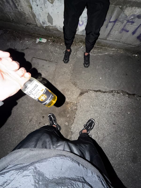 Two people share Corona beer in Pazardzhik alleyway