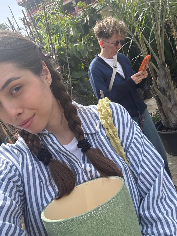 Woman shops at Tel Aviv plant nursery alongside wandering duck