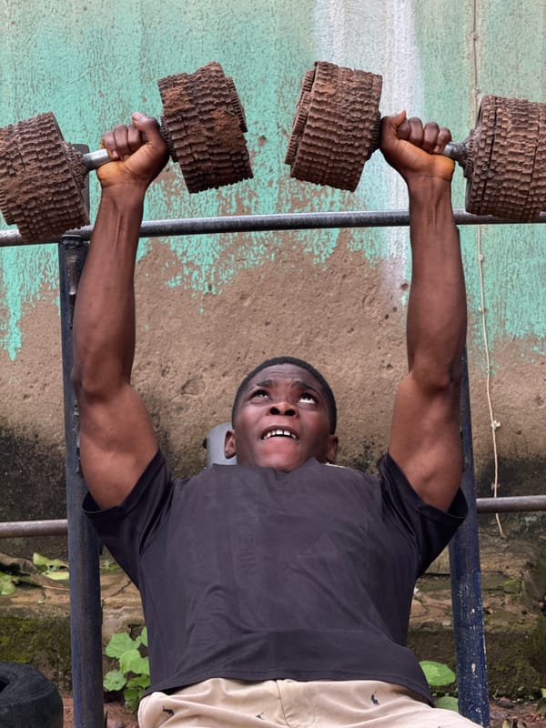 Lifting improvised weights at an outdoor gym in Akwanga, Nigeria